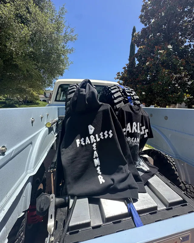 Black Fearless Dreamer hoodies in the back of a truck