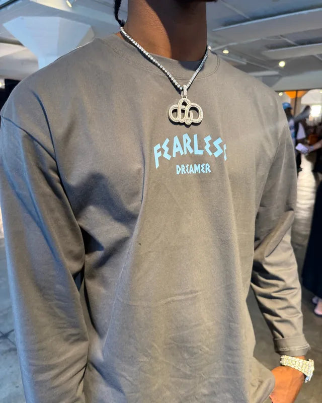 Gray Fearless Dreamer long sleeve tee worn with a chain